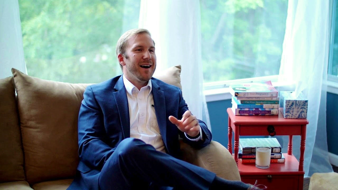 Man in Suit Smiling and Speaking